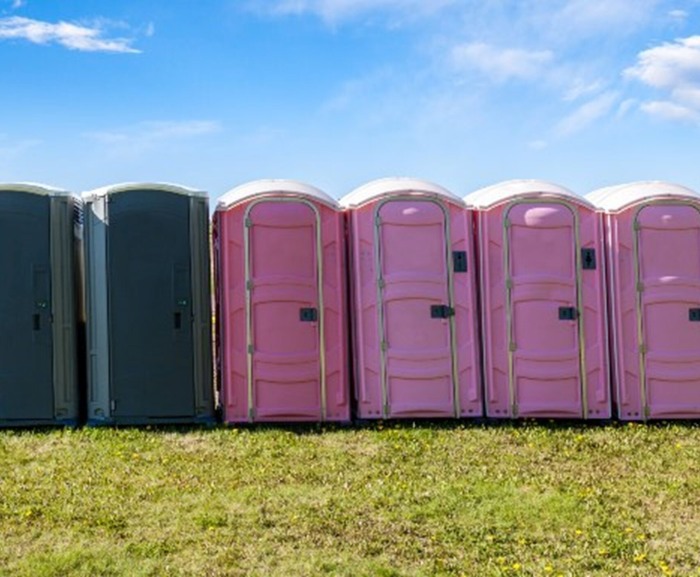 Multiple portable toilets are placed outdoors for an event in New York & New Jersey