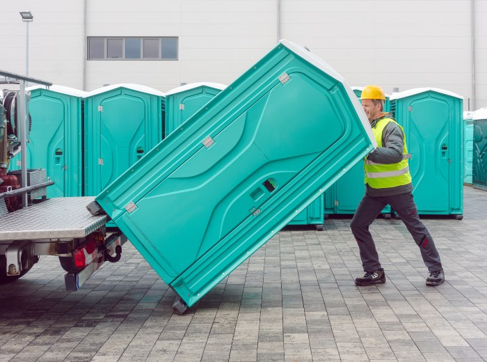 Rental lavatory being loaded on truck by a Man in NJ Warehouse